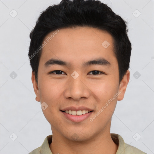 Joyful asian young-adult male with short  black hair and brown eyes