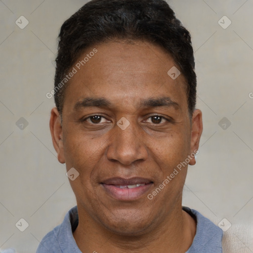 Joyful black adult male with short  black hair and brown eyes