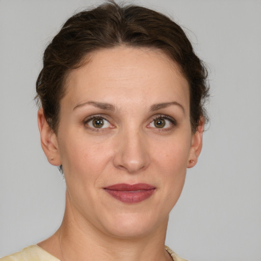 Joyful white adult female with short  brown hair and grey eyes