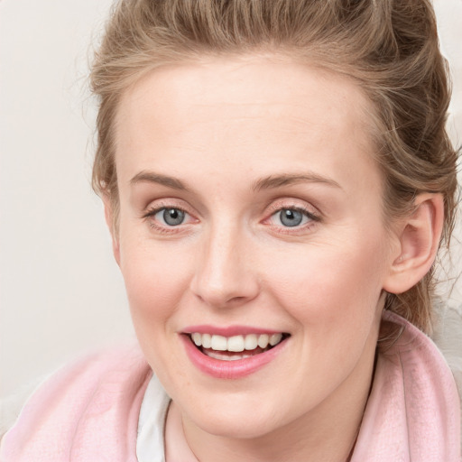 Joyful white young-adult female with long  brown hair and blue eyes