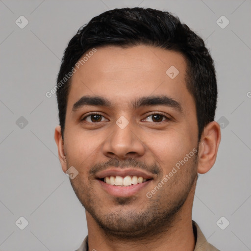 Joyful latino young-adult male with short  black hair and brown eyes