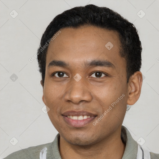 Joyful black young-adult male with short  black hair and brown eyes