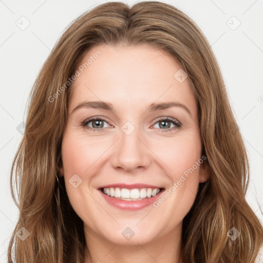 Joyful white young-adult female with long  brown hair and green eyes