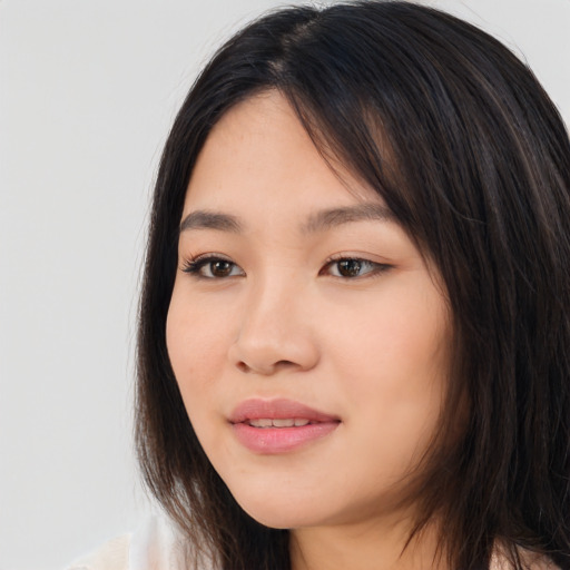 Joyful asian young-adult female with long  brown hair and brown eyes