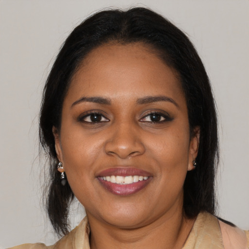 Joyful black young-adult female with medium  brown hair and brown eyes