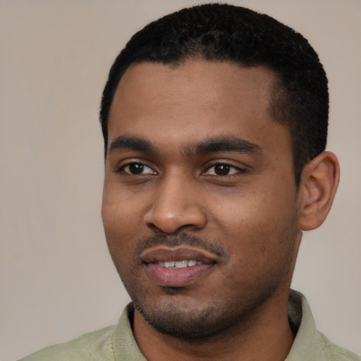 Joyful black young-adult male with short  black hair and brown eyes