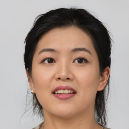 Joyful asian young-adult female with medium  black hair and brown eyes