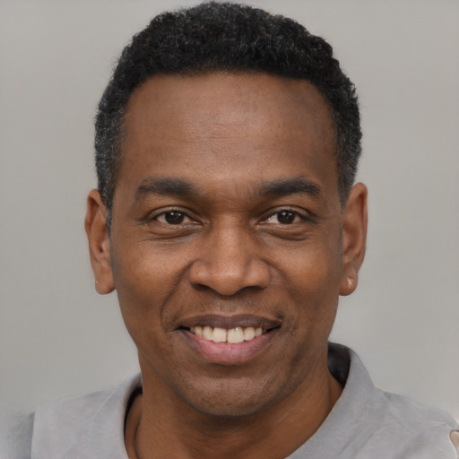 Joyful latino adult male with short  black hair and brown eyes