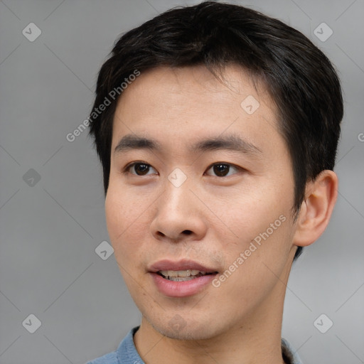 Joyful asian young-adult male with short  black hair and brown eyes