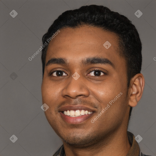 Joyful black young-adult male with short  black hair and brown eyes
