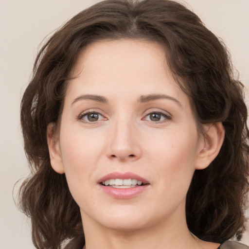 Joyful white young-adult female with medium  brown hair and grey eyes