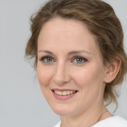 Joyful white adult female with medium  brown hair and grey eyes