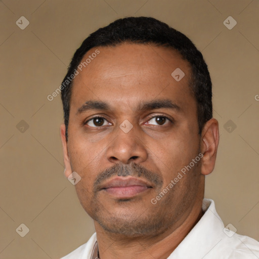 Neutral latino adult male with short  black hair and brown eyes
