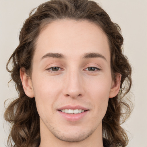 Joyful white young-adult male with medium  brown hair and brown eyes