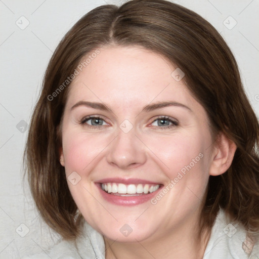 Joyful white young-adult female with medium  brown hair and blue eyes