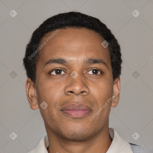 Joyful black young-adult male with short  brown hair and brown eyes