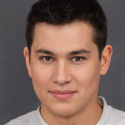 Joyful latino young-adult male with short  brown hair and brown eyes