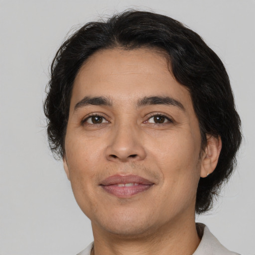 Joyful latino adult male with medium  brown hair and brown eyes