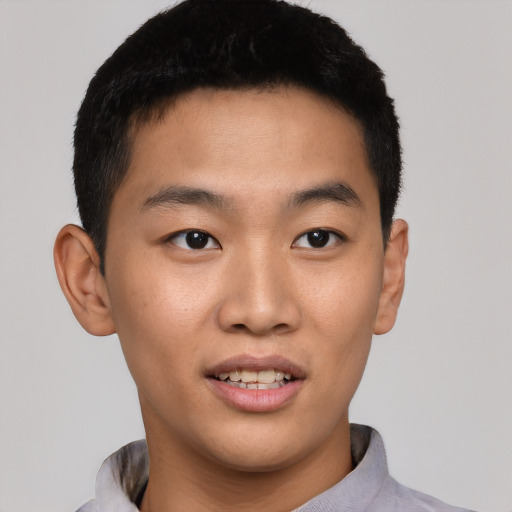 Joyful asian young-adult male with short  black hair and brown eyes