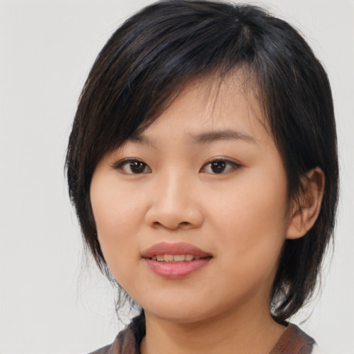 Joyful asian young-adult female with medium  black hair and brown eyes