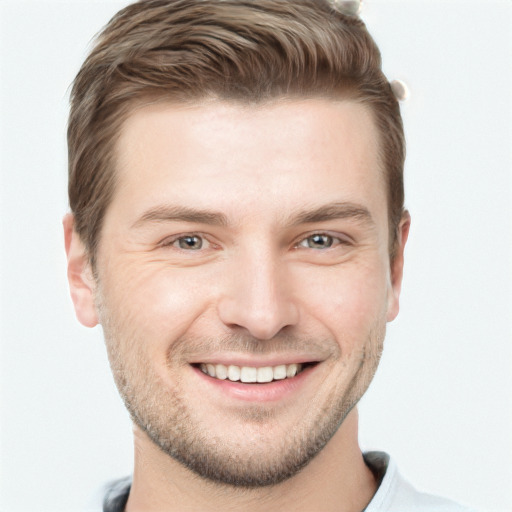 Joyful white young-adult male with short  brown hair and grey eyes