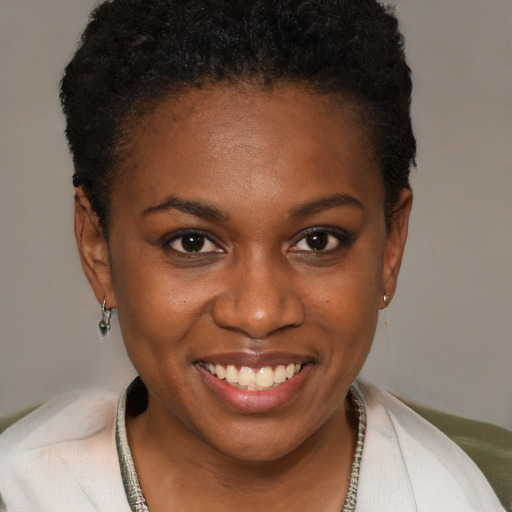 Joyful black young-adult female with short  brown hair and brown eyes