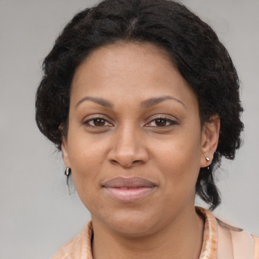 Joyful latino adult female with long  brown hair and brown eyes