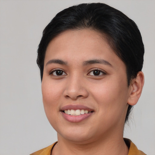 Joyful asian young-adult female with short  brown hair and brown eyes
