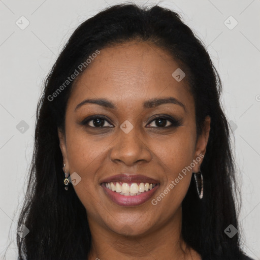 Joyful black young-adult female with long  brown hair and brown eyes