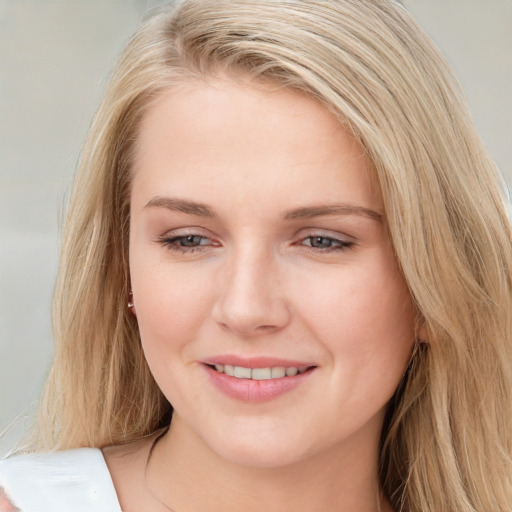 Joyful white young-adult female with long  brown hair and blue eyes