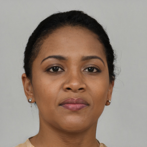 Joyful black young-adult female with short  brown hair and brown eyes