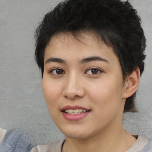 Joyful asian young-adult female with short  brown hair and brown eyes