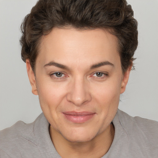 Joyful white adult female with short  brown hair and brown eyes