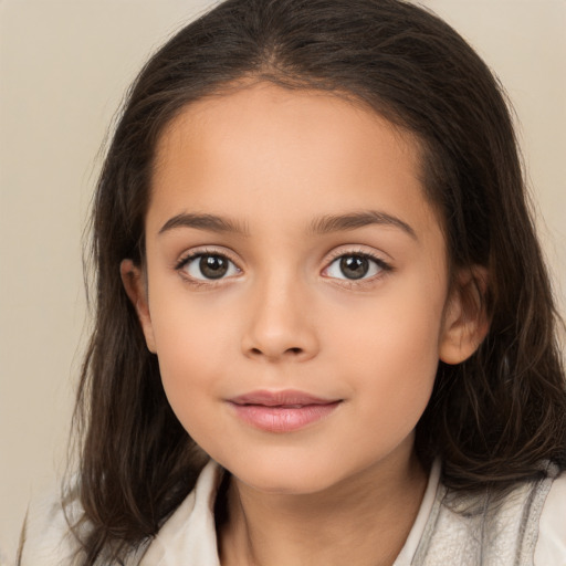 Joyful white child female with long  brown hair and brown eyes