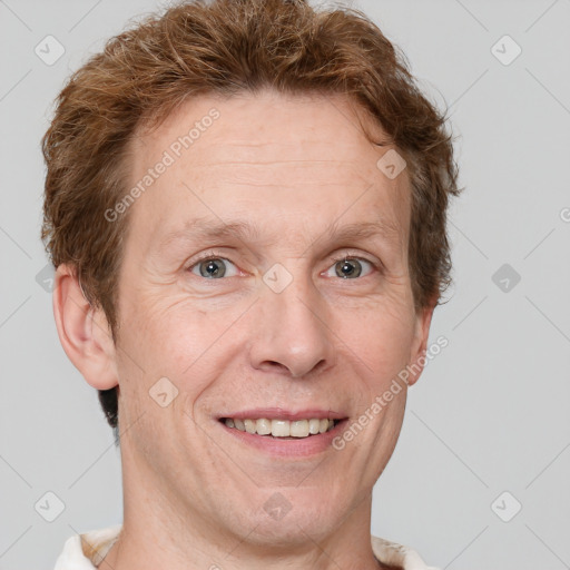 Joyful white adult male with short  brown hair and grey eyes