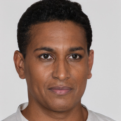 Joyful black young-adult male with short  brown hair and brown eyes