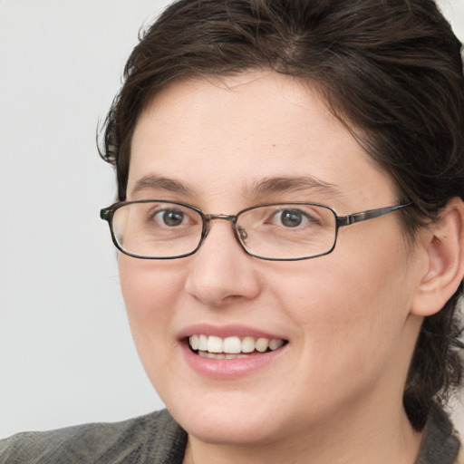 Joyful white young-adult female with medium  brown hair and blue eyes