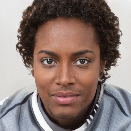 Joyful black young-adult female with short  brown hair and brown eyes