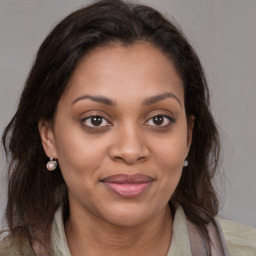 Joyful latino young-adult female with medium  brown hair and brown eyes