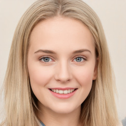 Joyful white young-adult female with long  brown hair and blue eyes