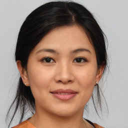 Joyful asian young-adult female with medium  brown hair and brown eyes