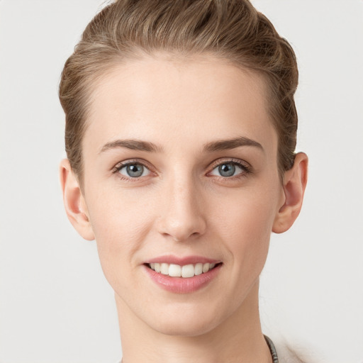 Joyful white young-adult female with short  brown hair and grey eyes