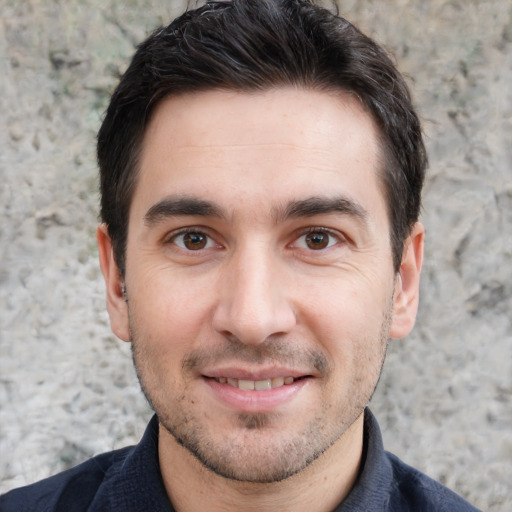 Joyful white young-adult male with short  black hair and brown eyes