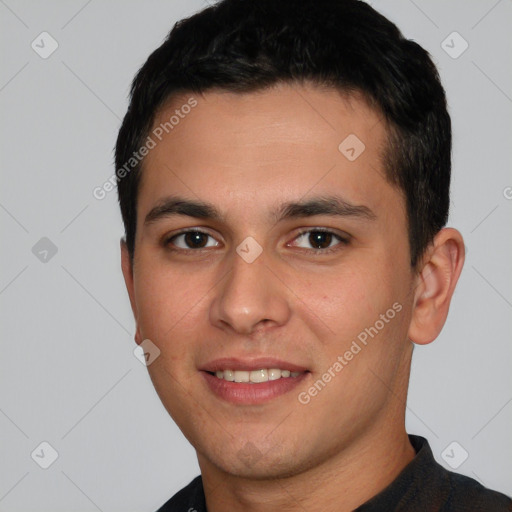 Joyful white young-adult male with short  black hair and brown eyes