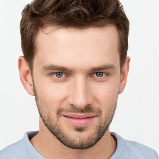 Joyful white young-adult male with short  brown hair and grey eyes