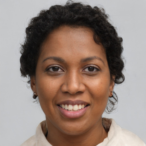 Joyful black young-adult female with short  brown hair and brown eyes