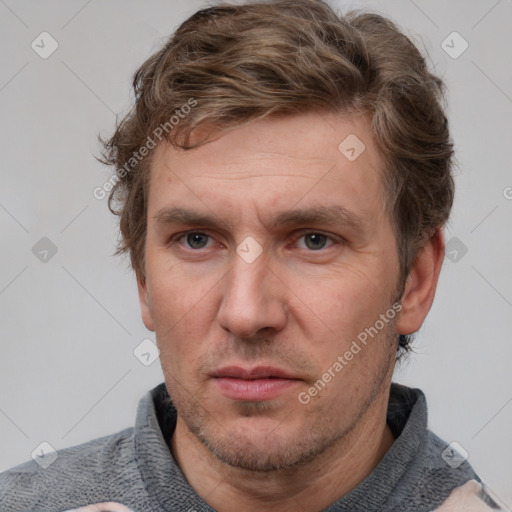 Joyful white adult male with short  brown hair and grey eyes