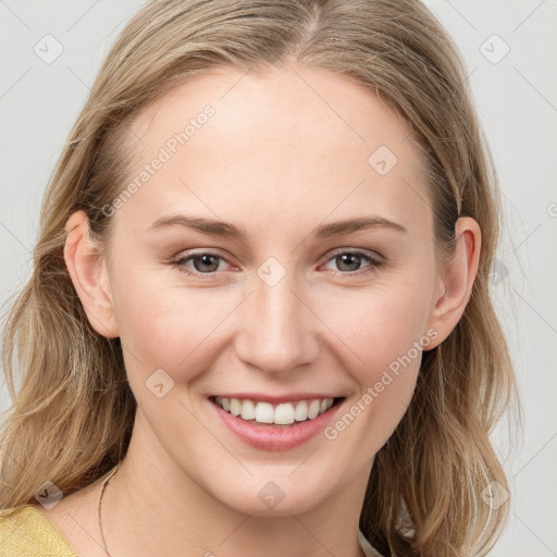 Joyful white young-adult female with long  brown hair and blue eyes