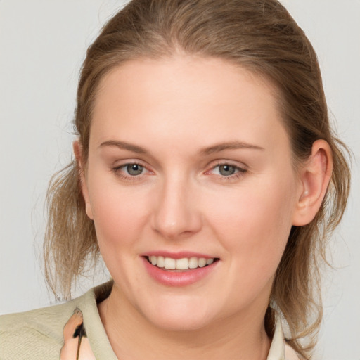 Joyful white young-adult female with medium  brown hair and blue eyes