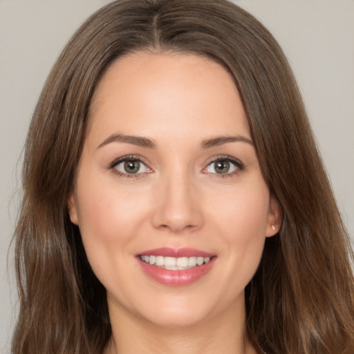 Joyful white young-adult female with long  brown hair and brown eyes